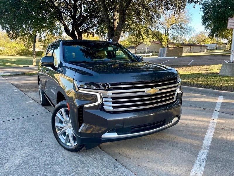 A black suv is parked in a parking lot.