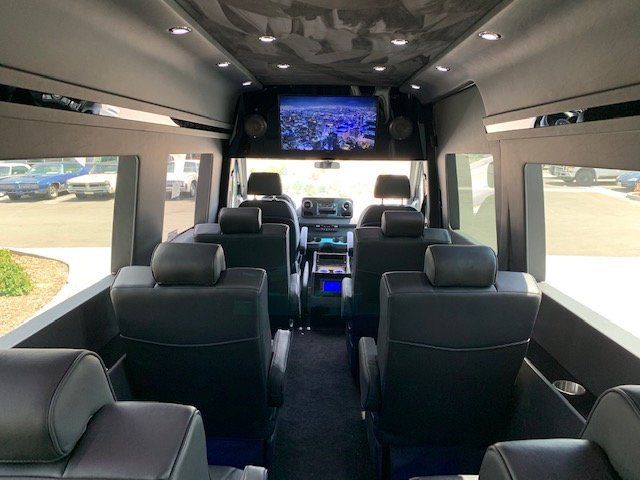 The inside of a van with a flat screen tv on the ceiling