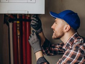 HVAC technician repairing residential heating and cooling system