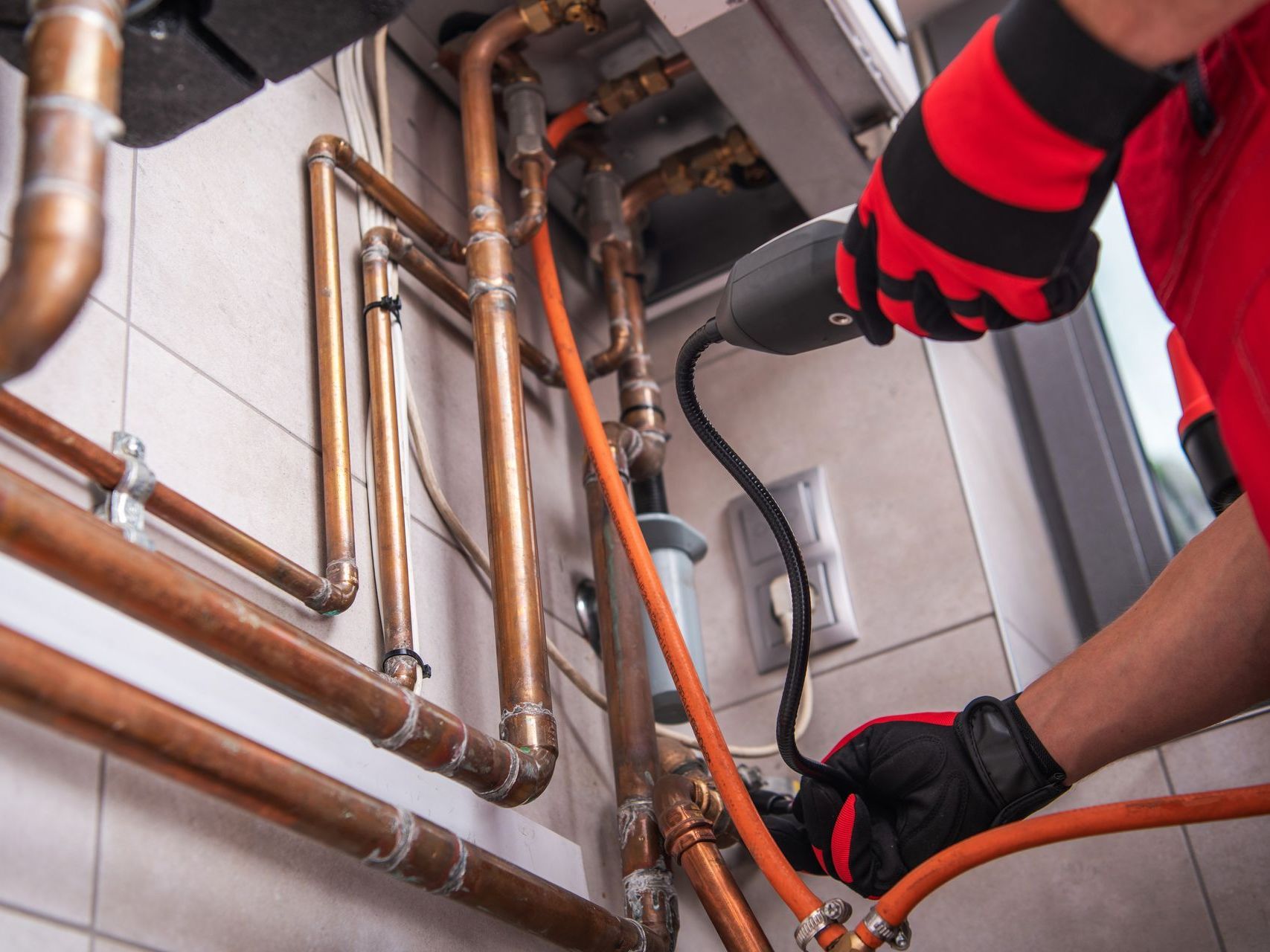 HVAC technician repairing residential heating and cooling unit