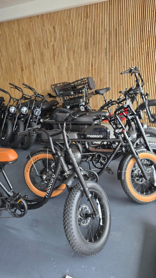 Several Black Electric Bikes With Tan Seats and Tires Parked Inside — E-Go-Try-Bikes in Nelson Bay, NSW