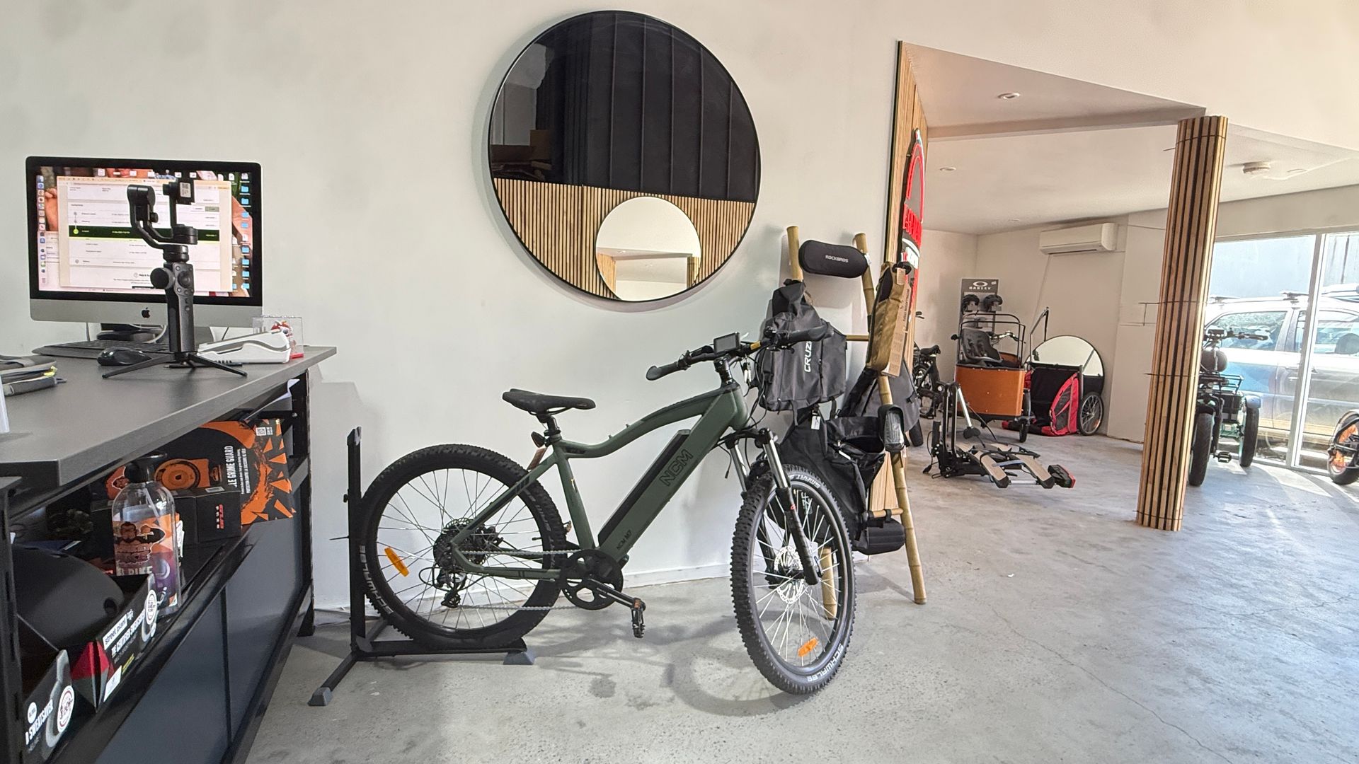 An Olive Green Electric Mountain Bike on A Stand in A Shop — E-Go-Try-Bikes in Nelson Bay, NSW