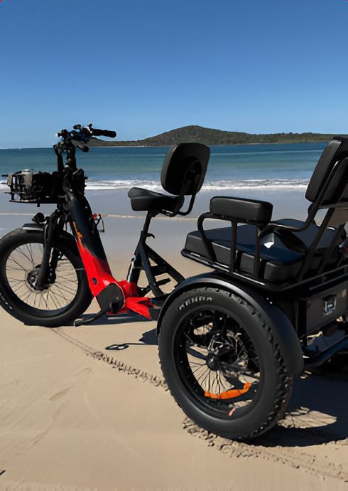 Black and Red Electric Tricycle on a Sandy Beach, Ocean in the Background — E-Go-Try-Bikes in Nelson Bay, NSW