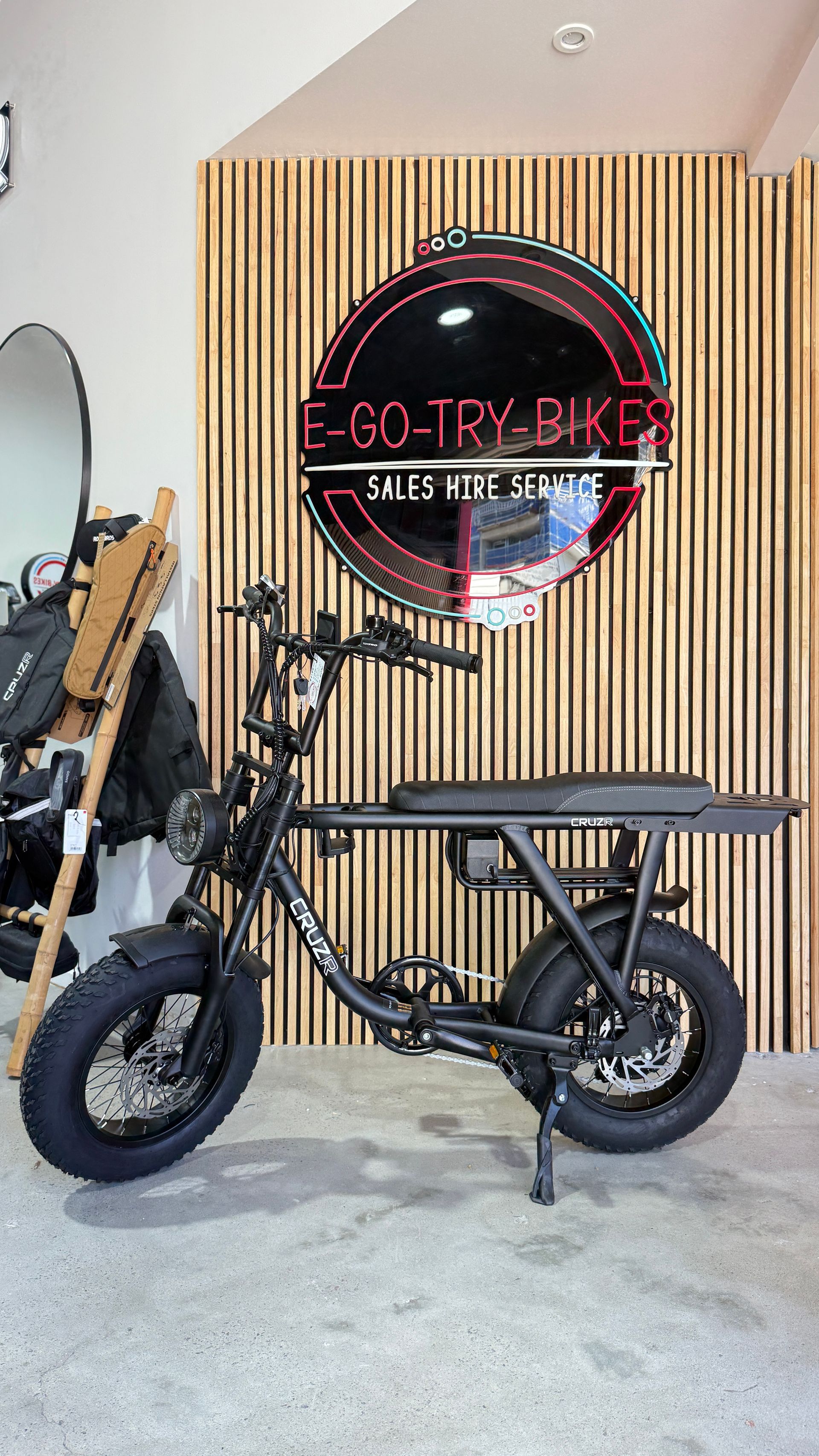 A Black Electric Moped Stands in Front of A Wood-Slatted Wall — E-Go-Try-Bikes in Nelson Bay, NSW