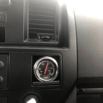 Dashboard interior with an analog gauge, likely for monitoring pressure.