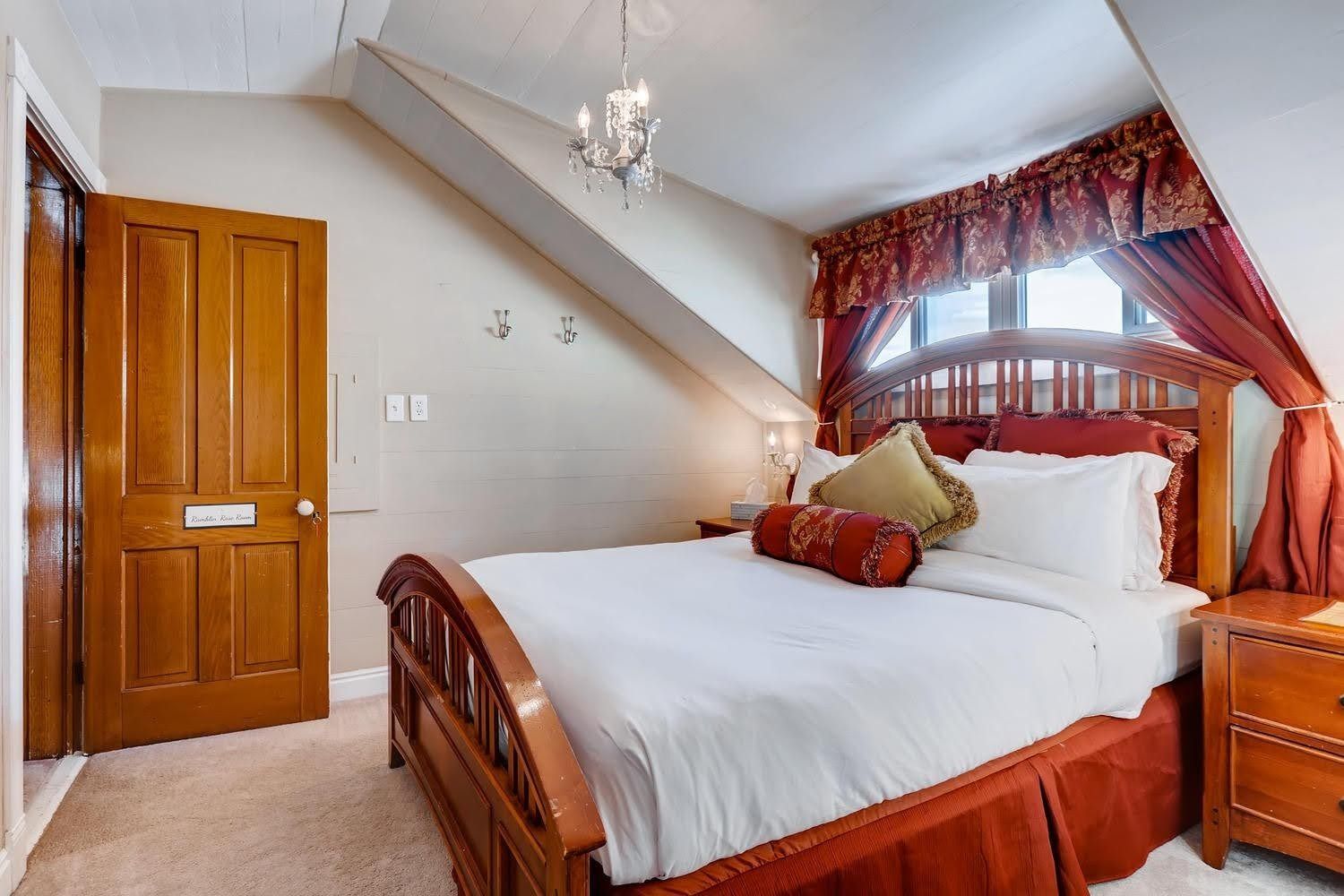 A bedroom with a king size bed and a window