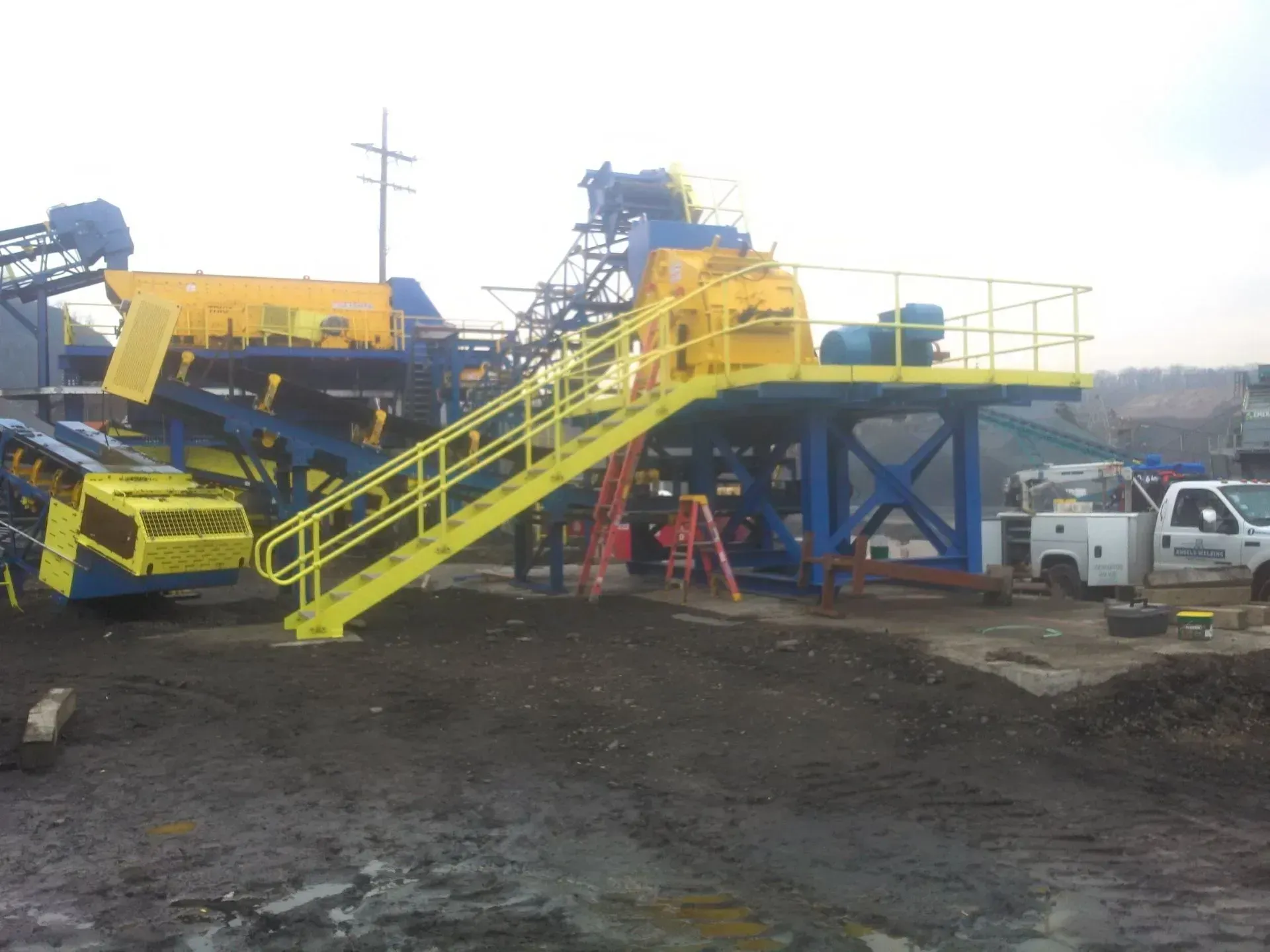 A yellow staircase leading up to a large machine.