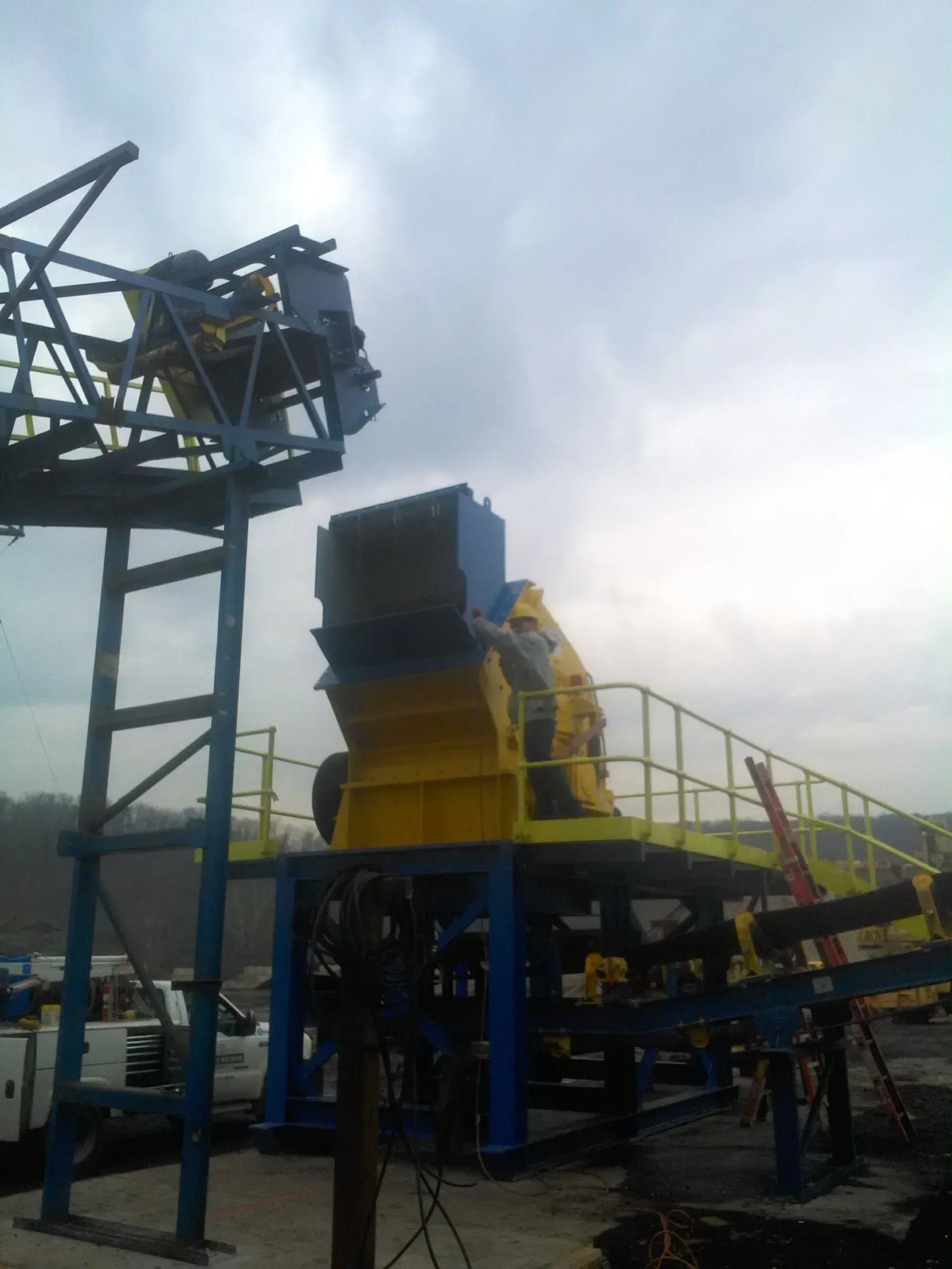 A yellow and blue machine with a railing on top of it.