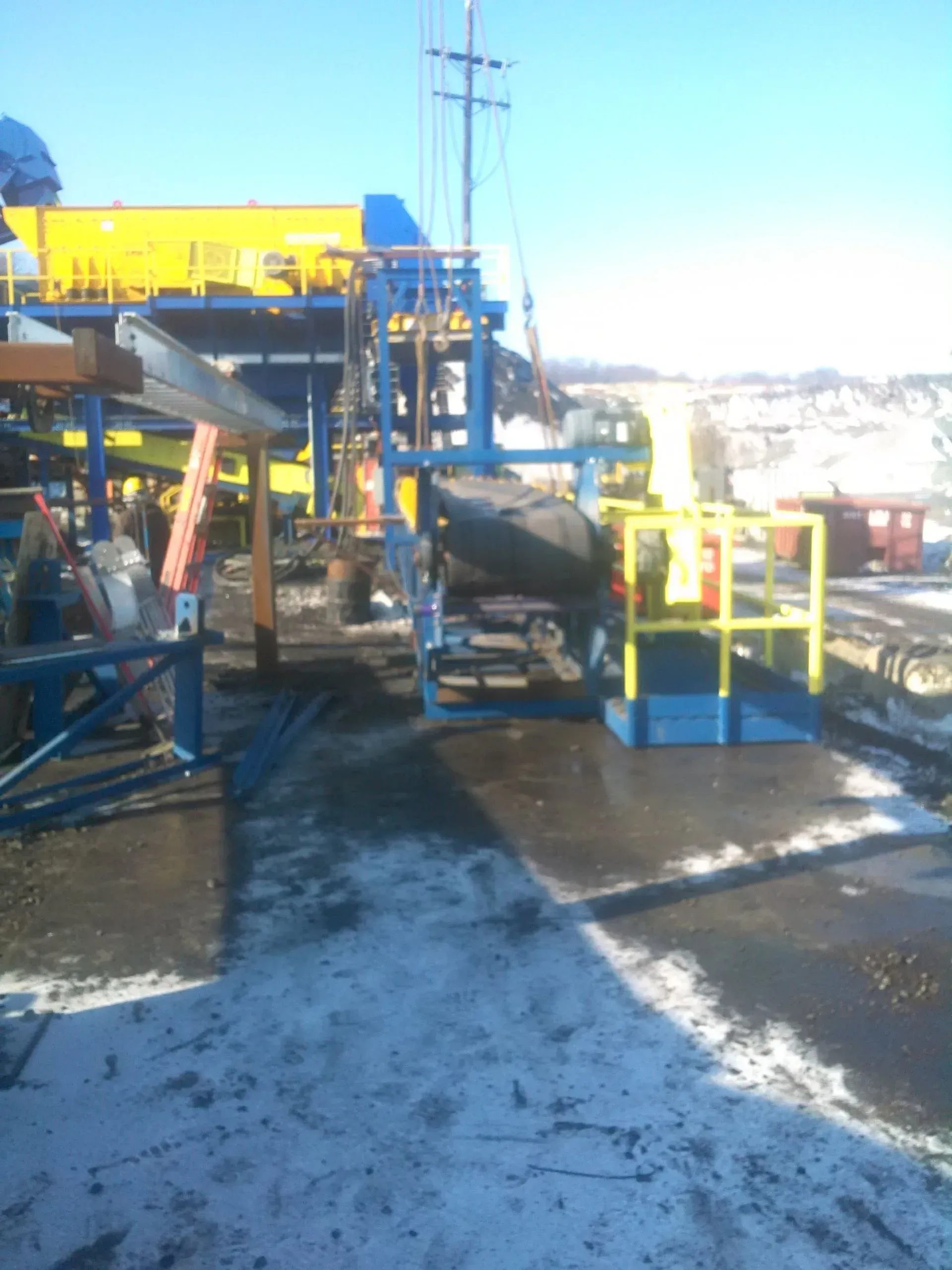 A construction site with a yellow building in the background.