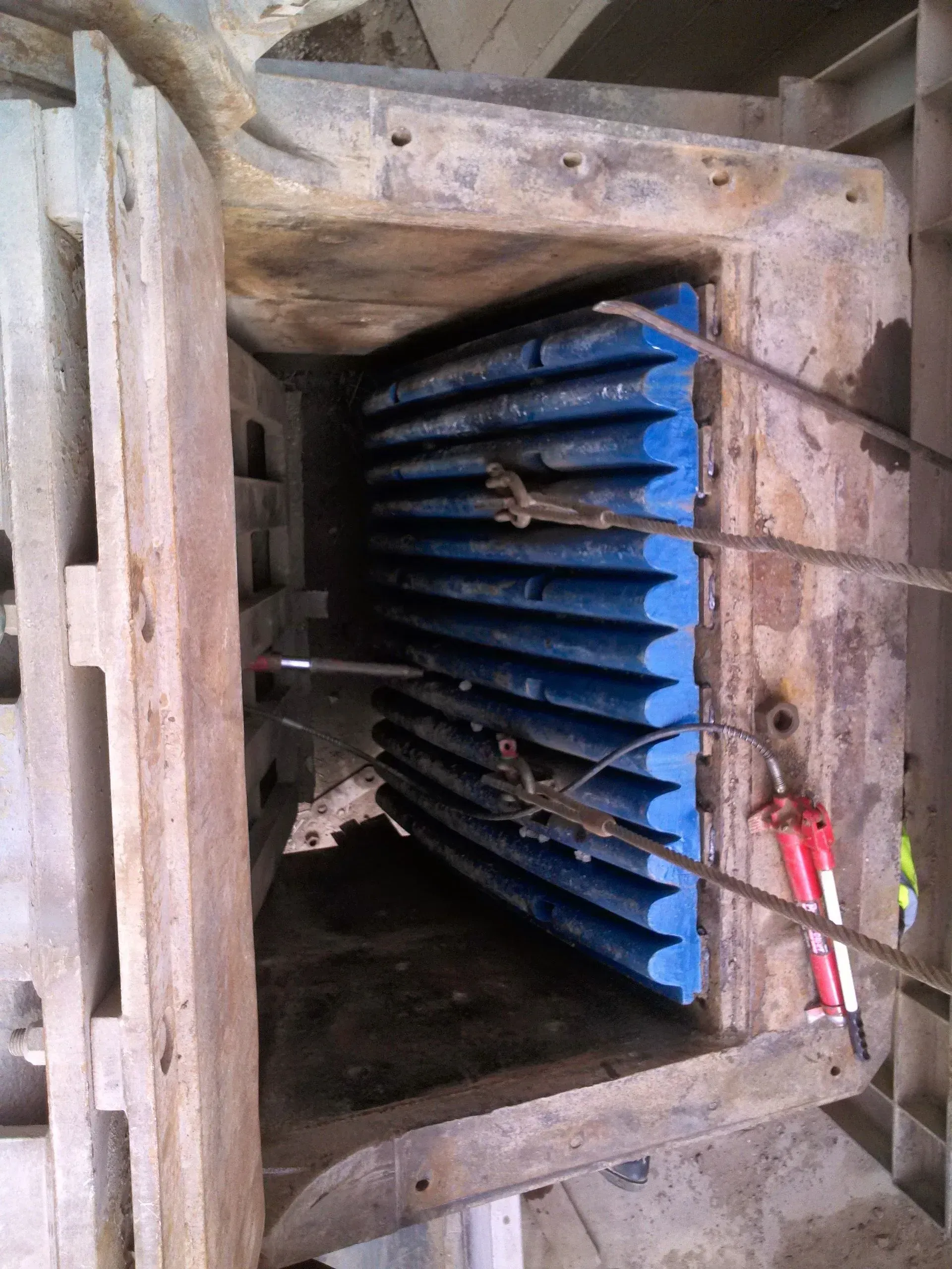 A close up of a machine with a blue filter and a pair of pliers.