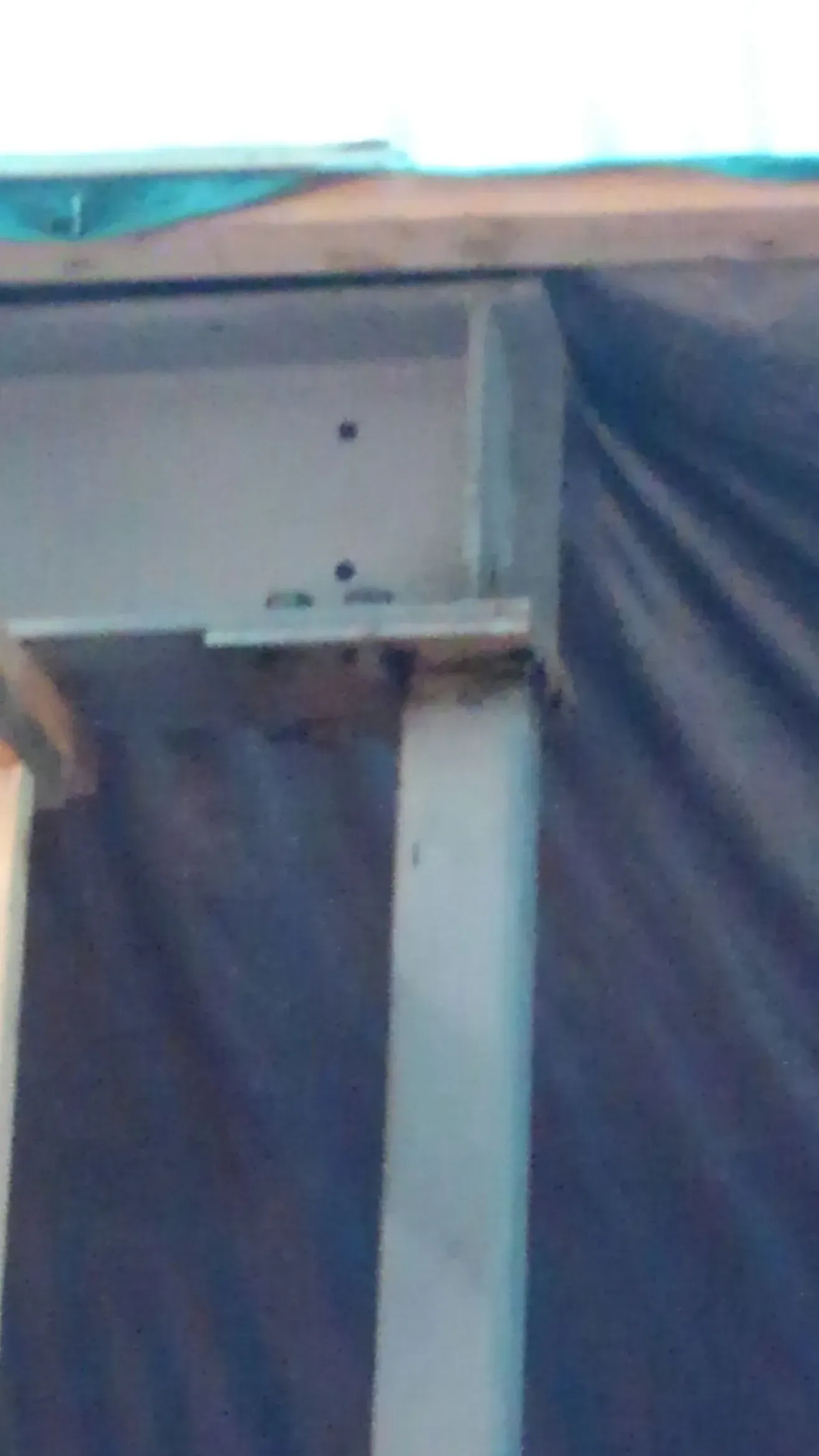 A white table is sitting in front of a blue curtain.