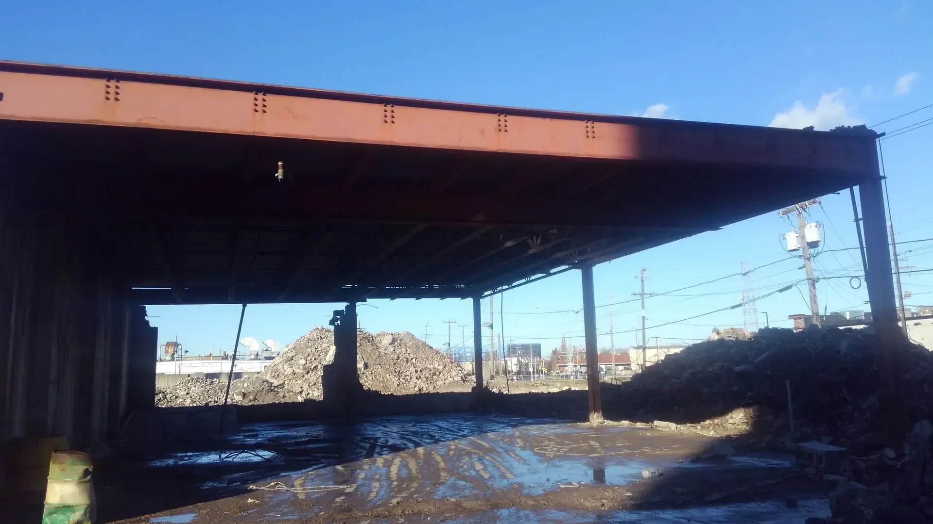 A rusty metal structure with a blue sky in the background.