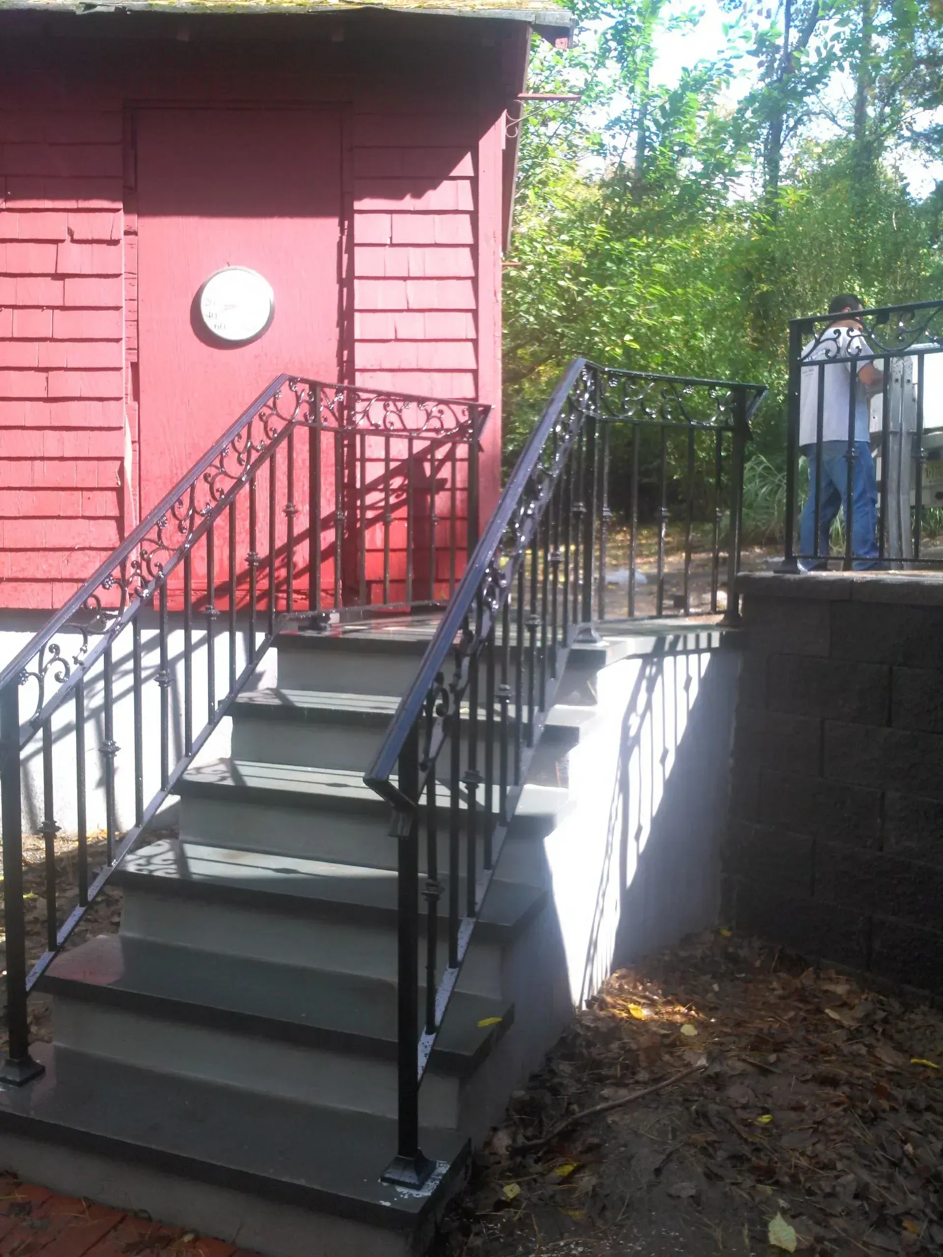 A set of stairs leading up to a red building.