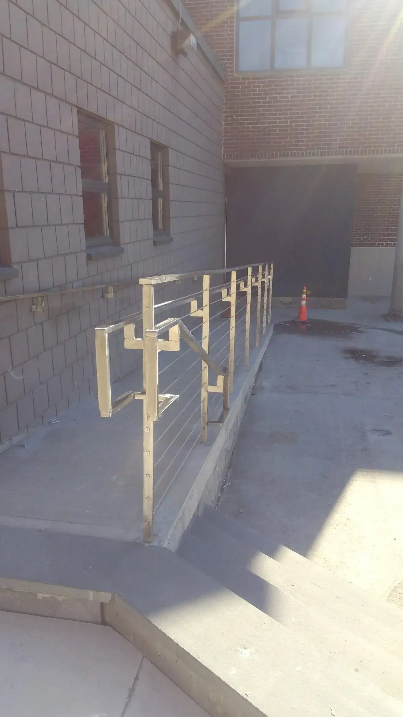 A ramp is being built in front of a brick building.