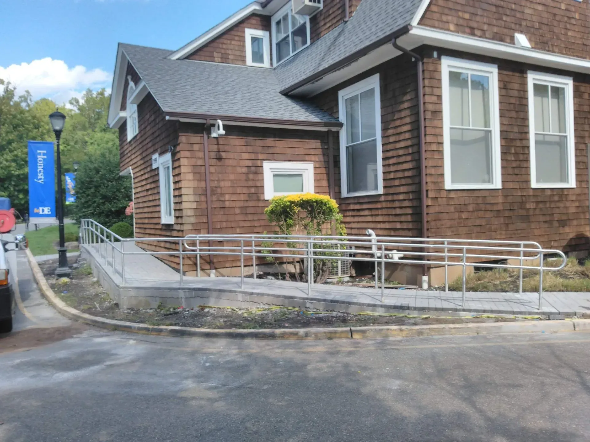 A large brown house with a ramp leading to it