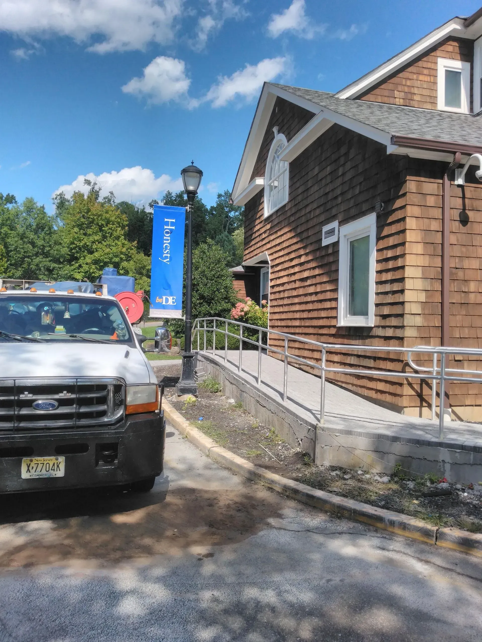 A ford truck is parked in front of a house.