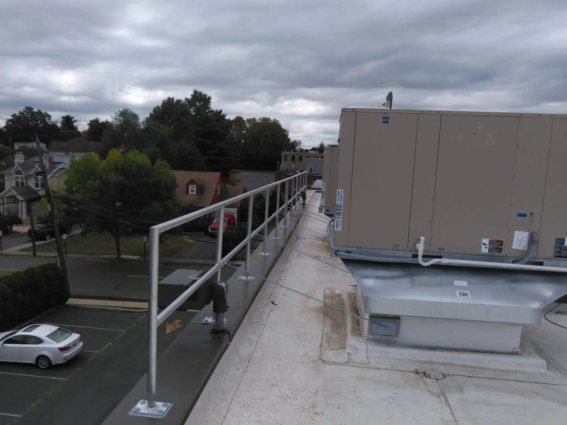 A white car is parked on the roof of a building.