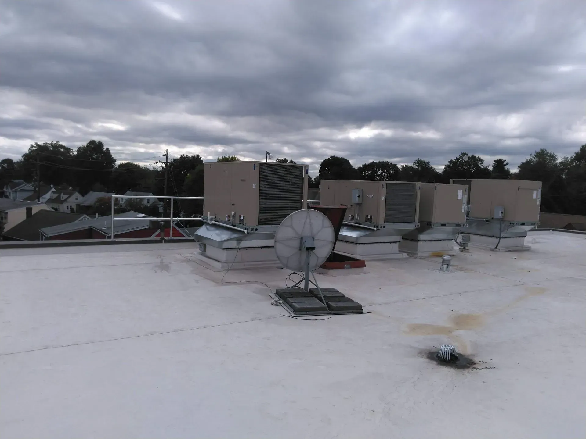 A white roof with a satellite dish on top of it.