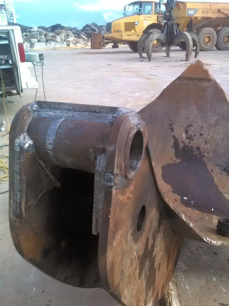 A yellow truck with the word volvo on it.