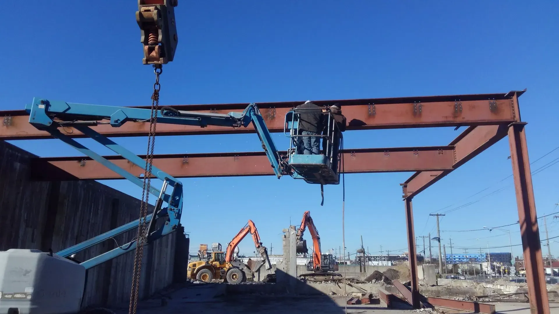 A large metal structure is being lifted by a crane.