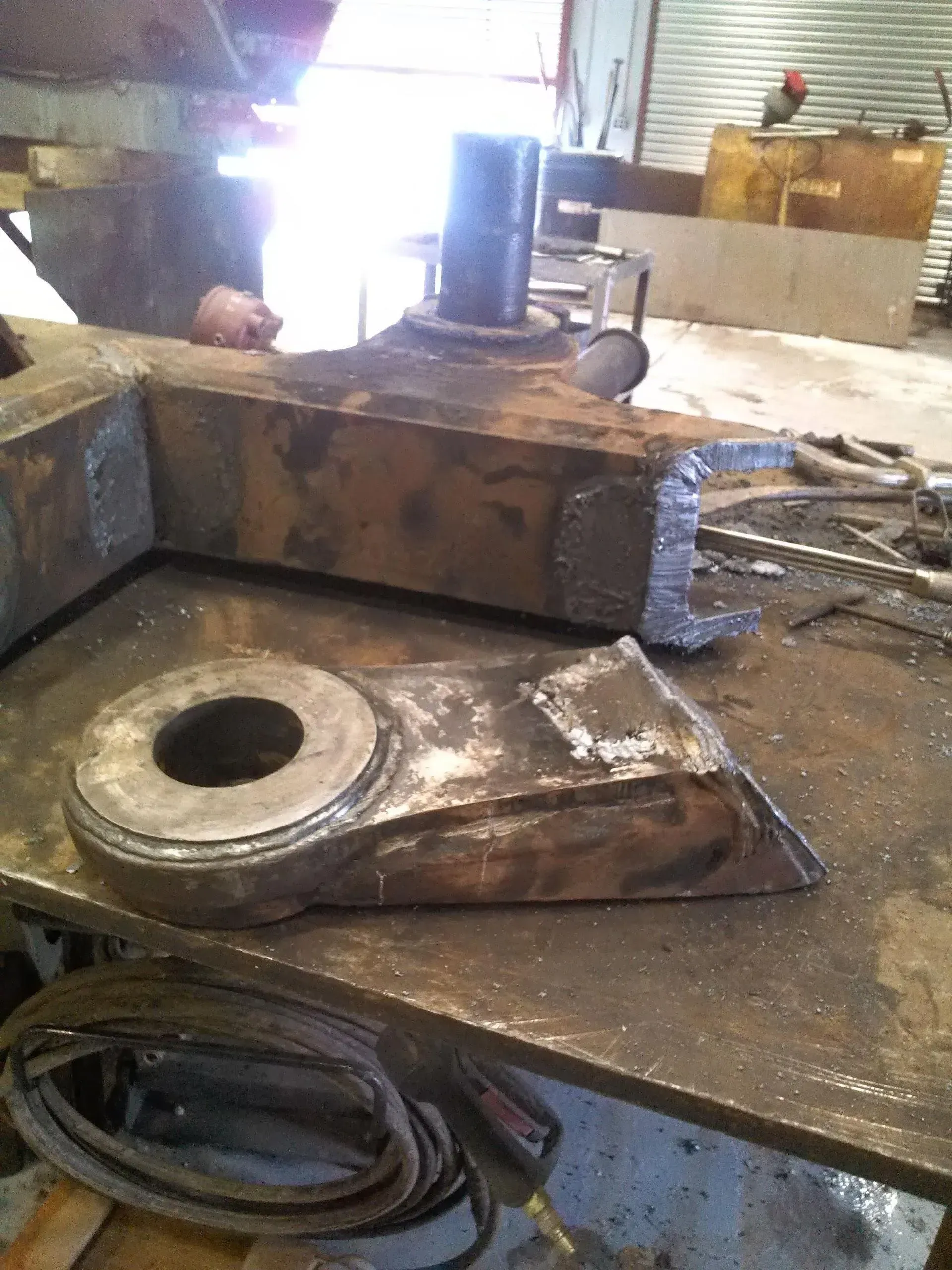 A piece of metal with a hole in it is on a table.