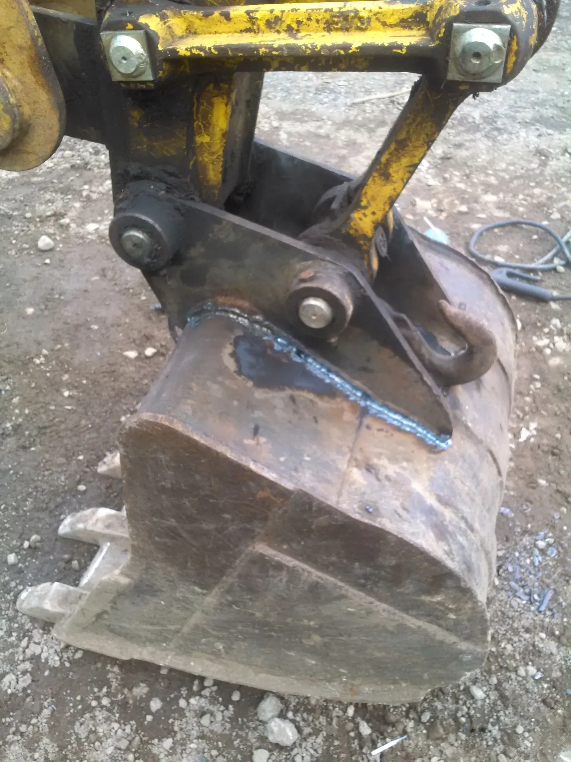 A close up of a bulldozer bucket on the ground.