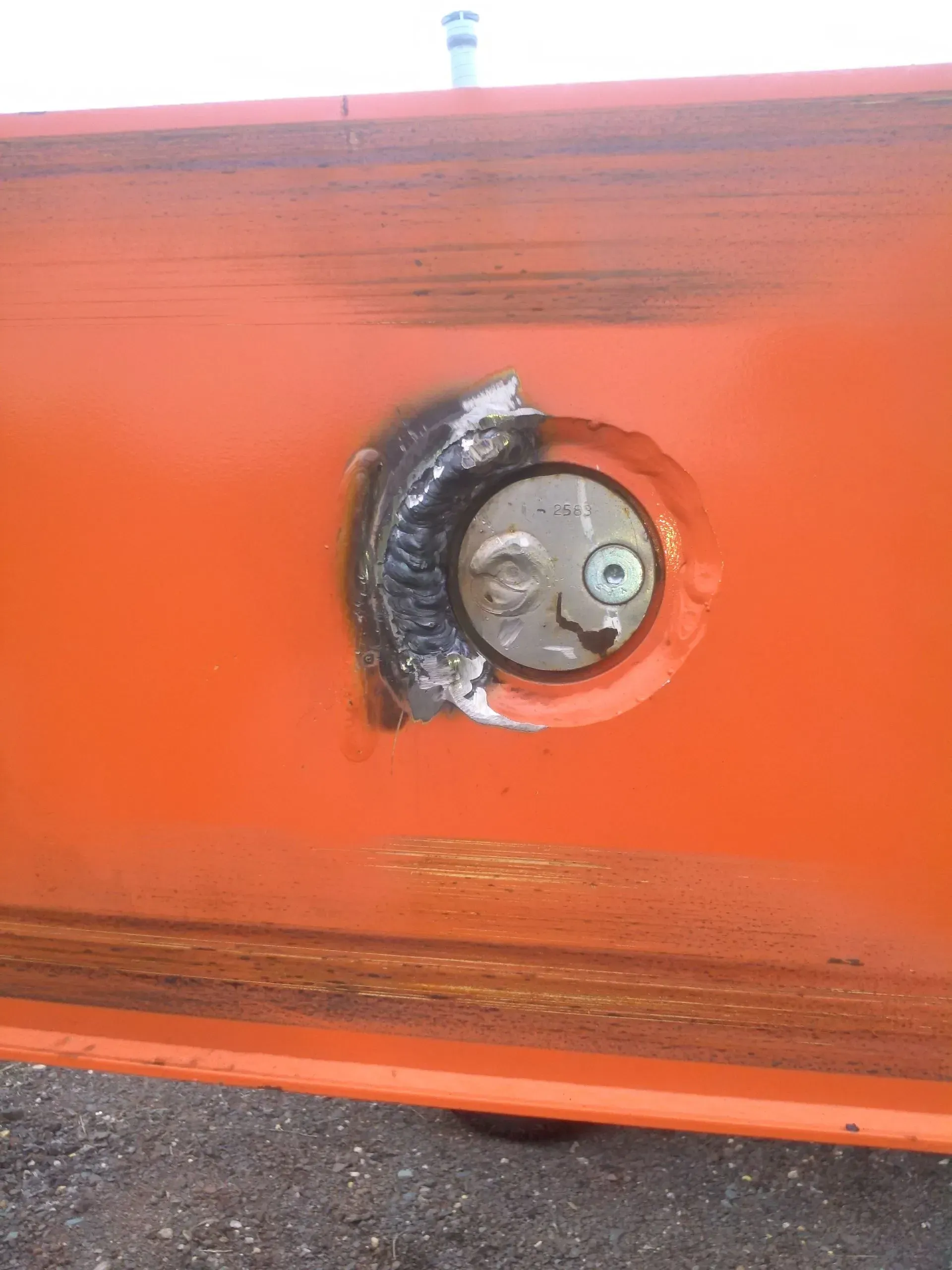 A close up of an orange object with a hole in it.