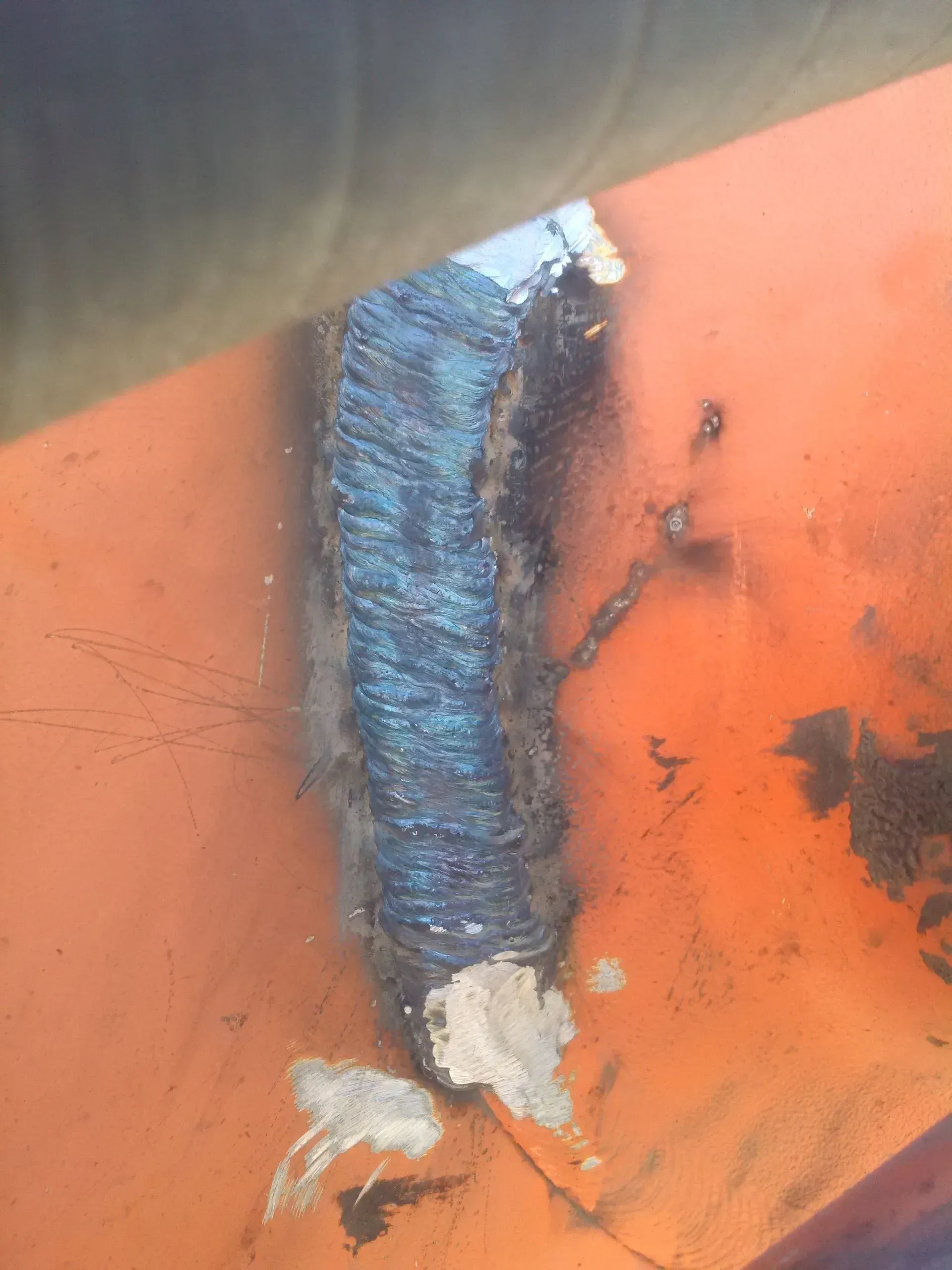A close up of a welding joint on a piece of metal.