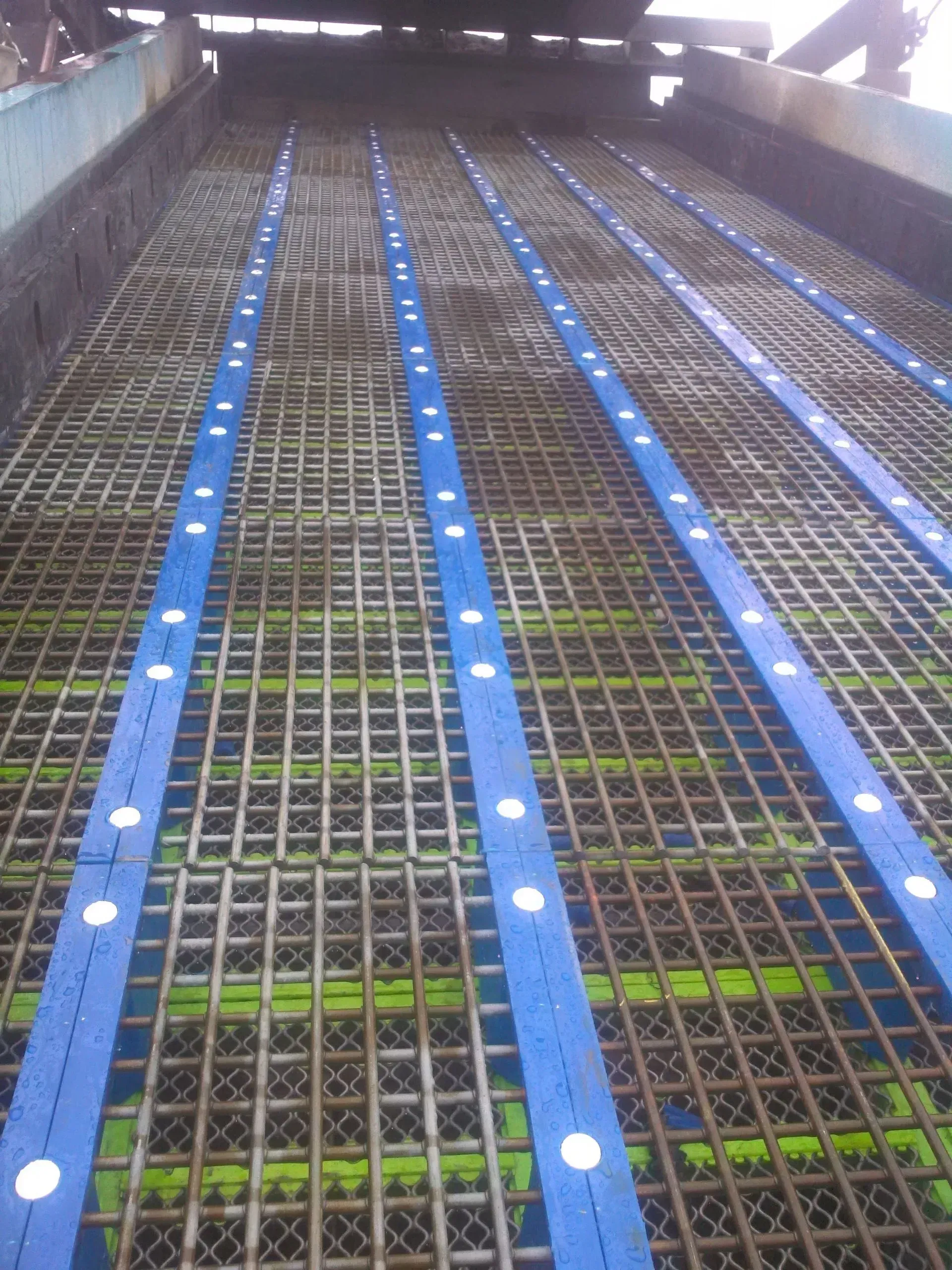 A metal grid with blue stripes on it.