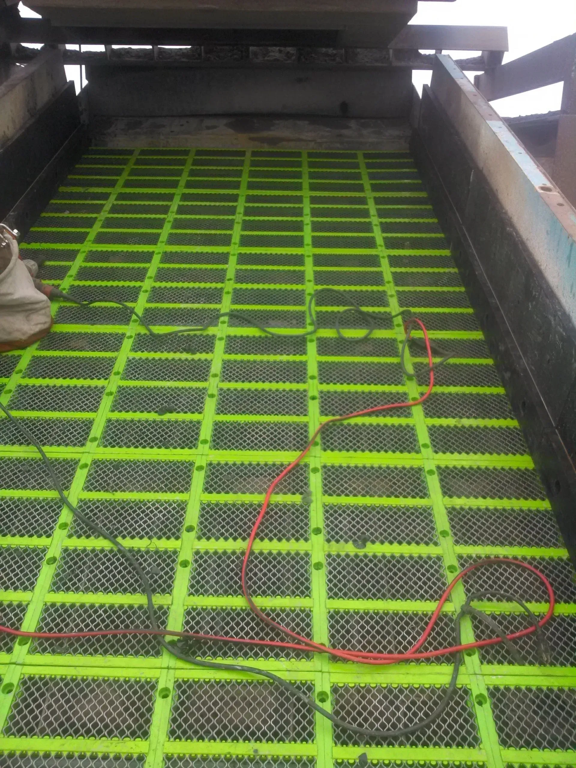 A person is standing on top of a green screen.