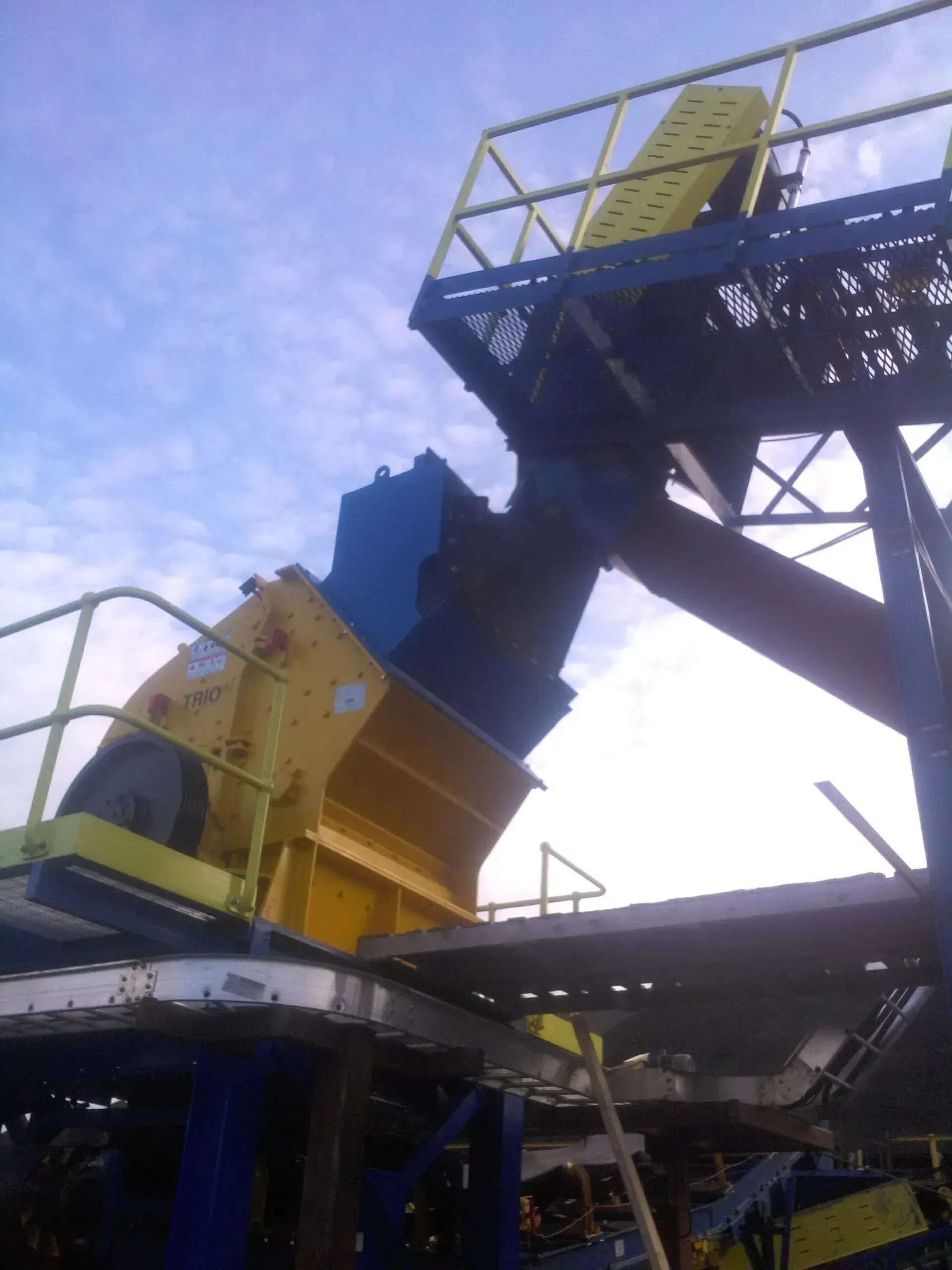 A yellow and blue machine with a ladder on top of it.