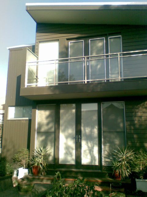 windowsA house with a balcony and a lot of