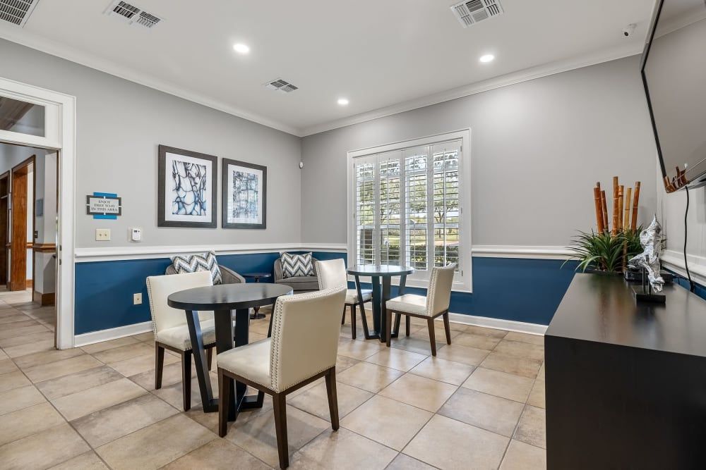 Resident lounge with tables and chairs at Marquis at The RIM in Northwest San Antonio, TX.