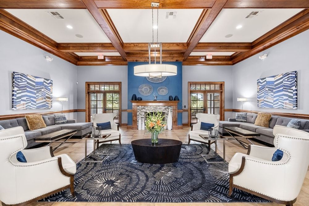 Spacious clubhouse filled with furniture and a fireplace at Marquis at The RIM in Northwest San Antonio, TX.