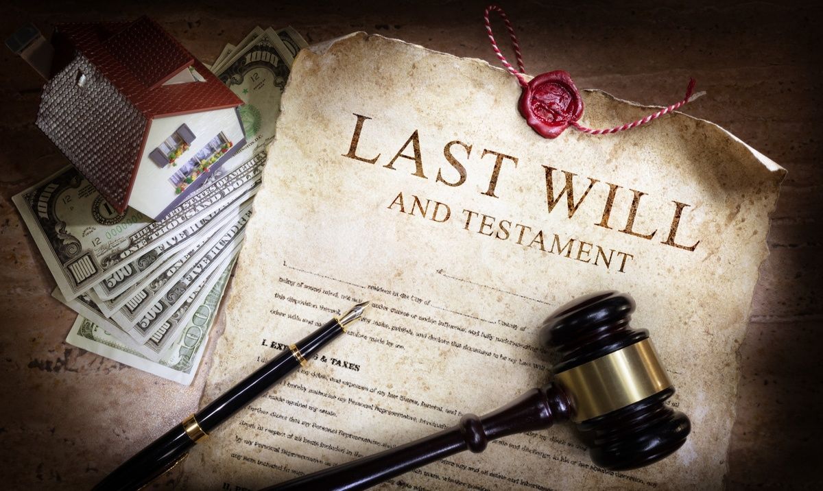 A wooden gavel is sitting on top of a last will and testament.