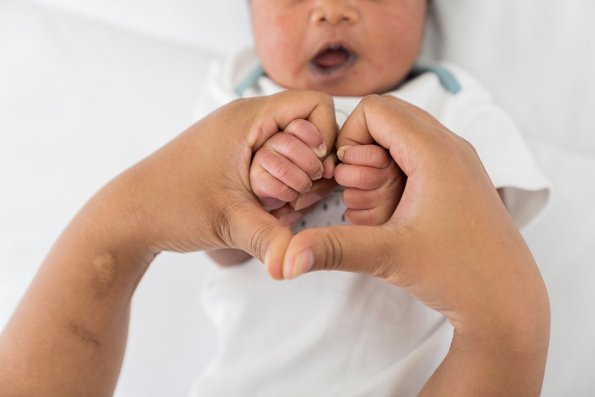 Hands of Nurse Holding Newborn Baby — Brandon, MS — Capital City Children & Adolescent Clinic, PLLC