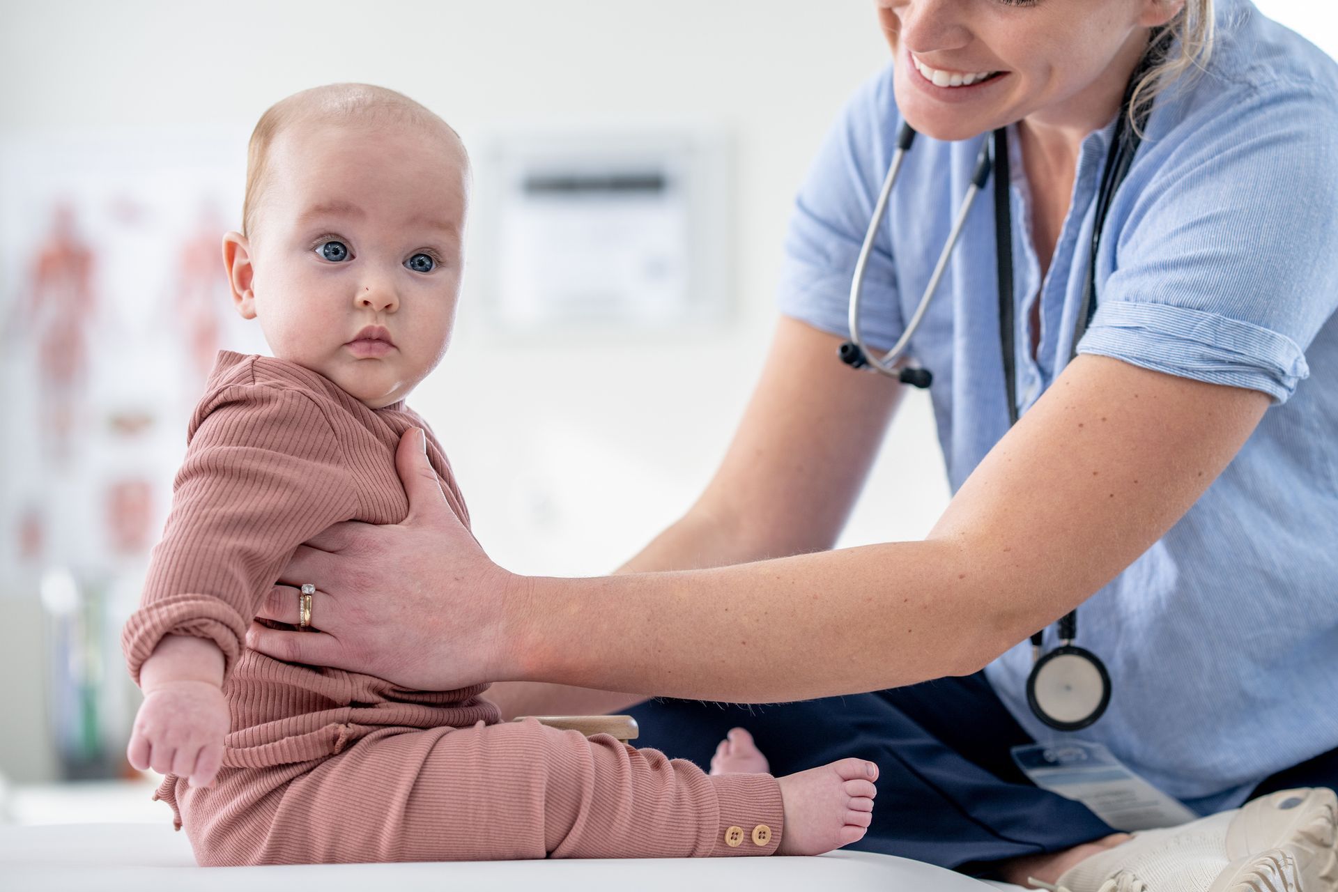 A Baby Holding by a Doctor — Jackson, MS — Capital City Children & Adolescent Clinic, PLLC