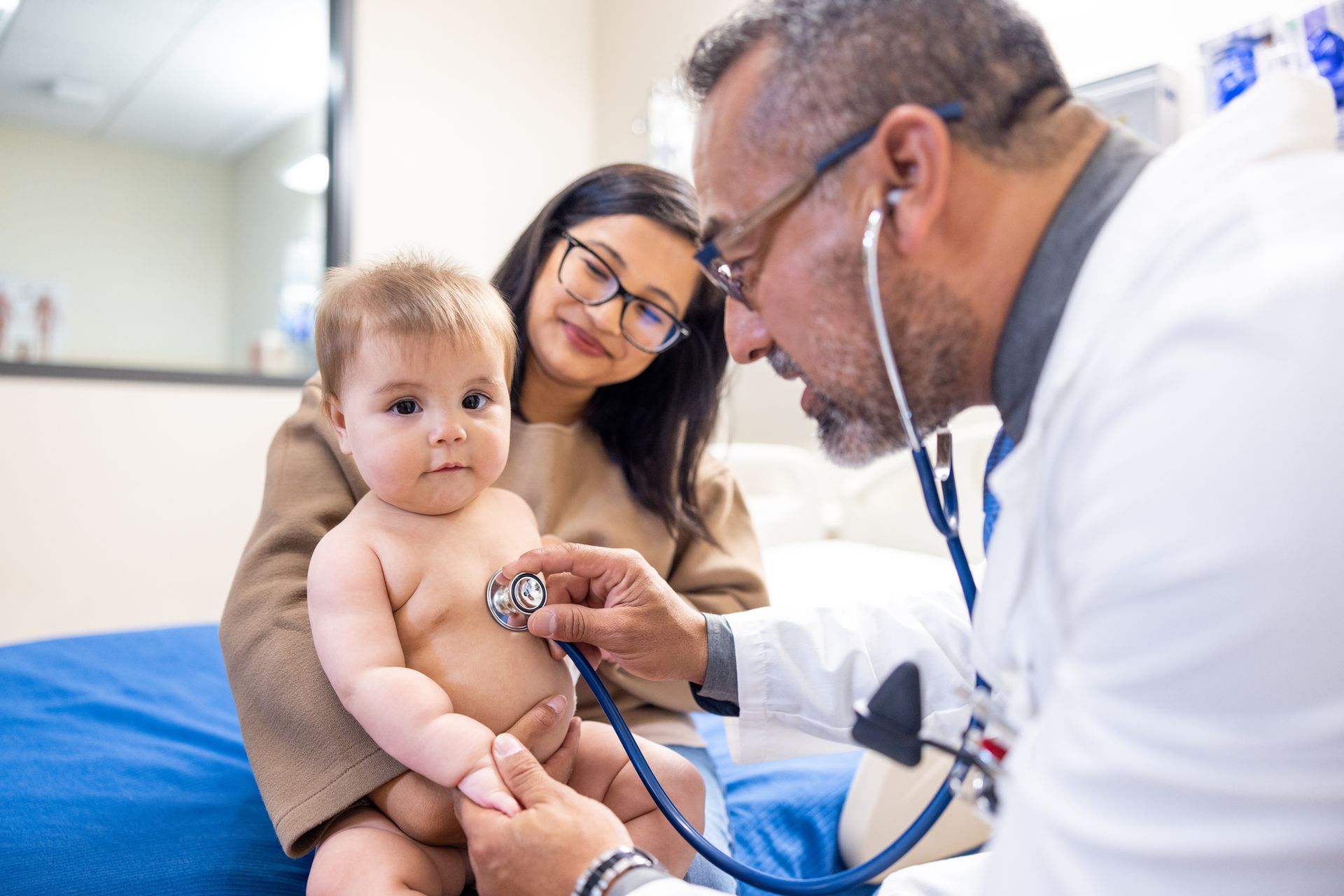 Doctor Using a Stethoscope to Listen to the Heartbeat of a Baby — Jackson, MS — Capital City Children & Adolescent Clinic, PLLC