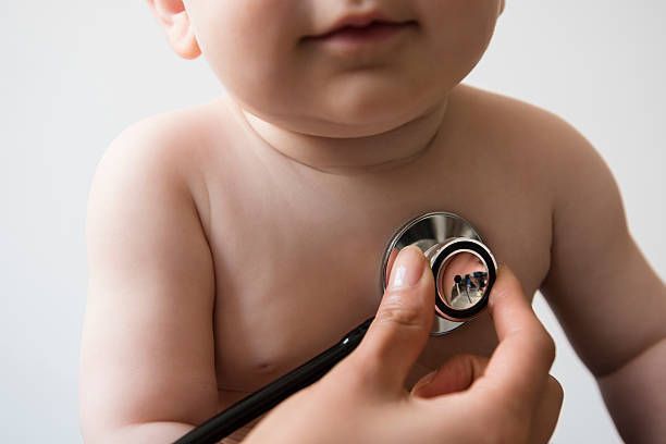 Doctor Listening to Chest of Baby Boy with Stethoscope — Madison, MS — Capital City Children & Adolescent Clinic, PLLC