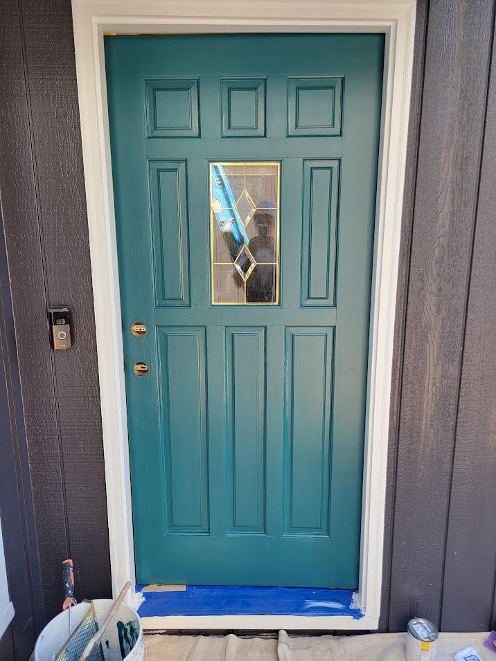 A blue door with a window is sitting on a table.