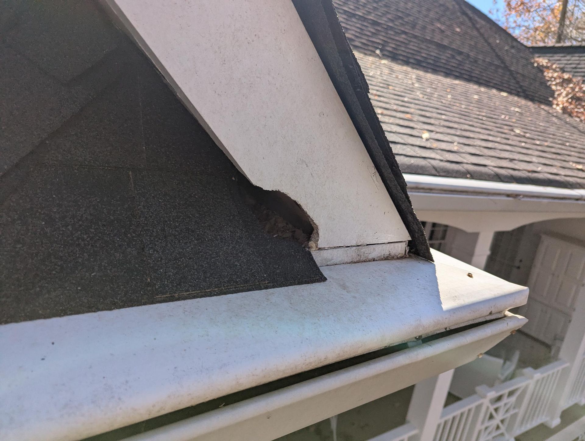 Close-up of a screw in a metal frame, near a wooden surface.