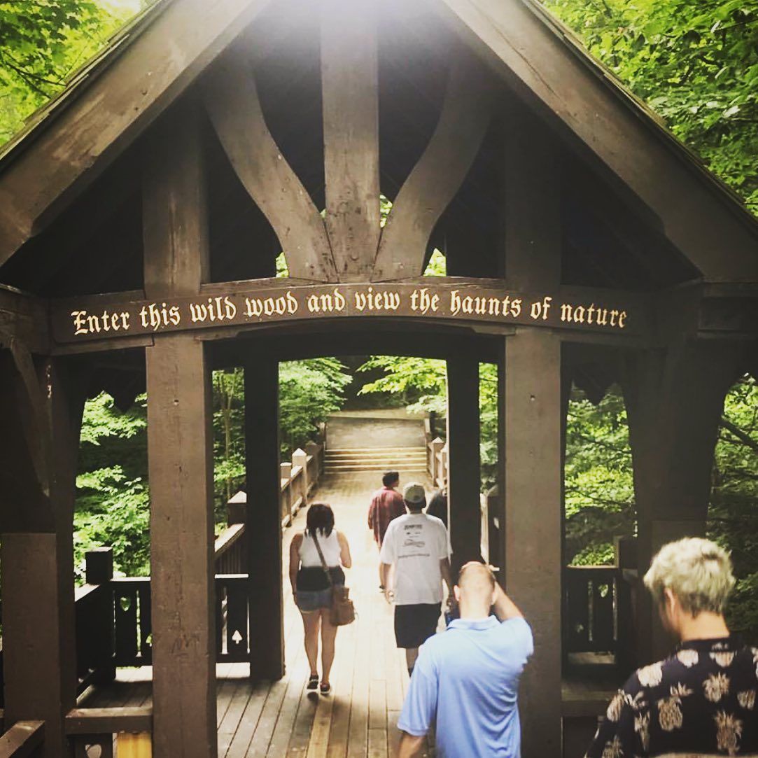 Wooden bridge entrance with sign: 