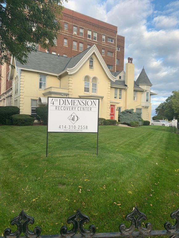 Yellow building with a sign for 