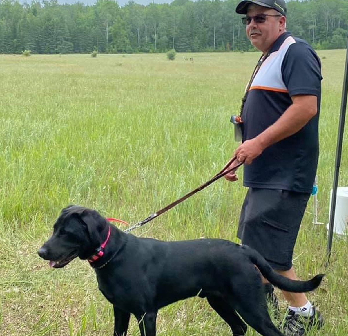 Black Dog And A Trainer — Freeland, MI, — Windy Acres Kennels