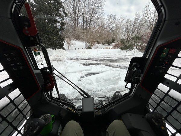 plowing shown from inside a skidsteer
