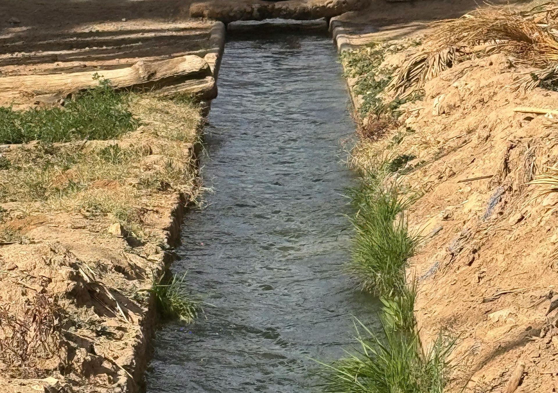 Irigation and Water Management Services cause water to run through 2 dirt banks