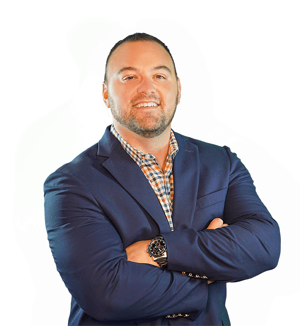 A man in a blue suit and plaid shirt with his arms crossed