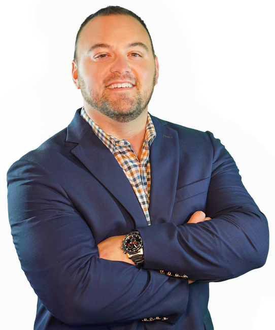A man in a suit and plaid shirt with his arms crossed