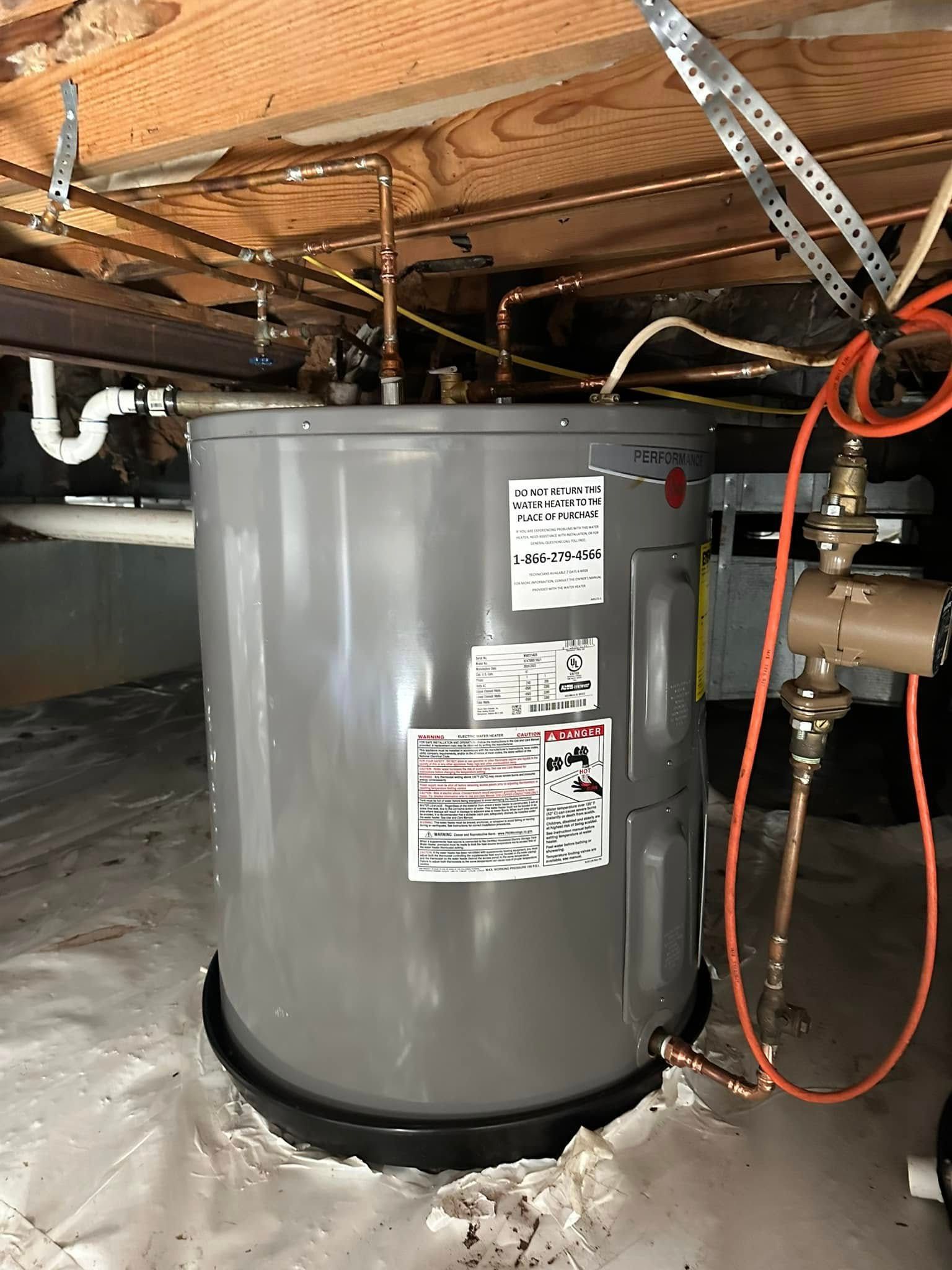 Water heater in a crawl space with copper pipes and electrical wiring.
