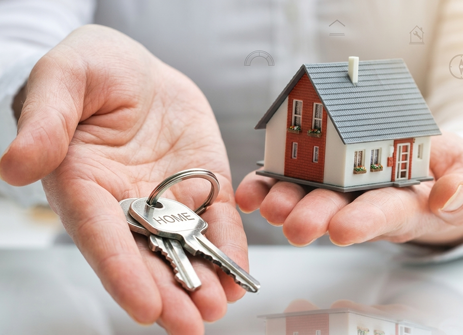 Hands holding house keys and a small model home.